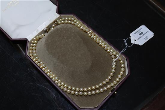 A Mikimoto pearl single strand long necklace with gold ball clasp (tests as 18ct) in Mikimoto box, 50 cm.